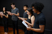 Drama students reading a script in an acting class