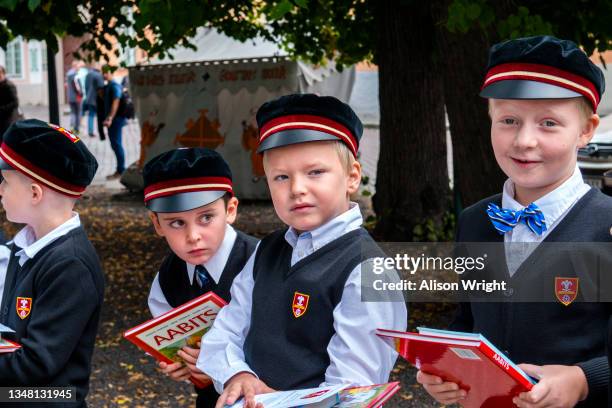 Estonia, Tallinn, Old town, UNESCO World Heritage Site, Children in uniforms bring flowers to their teachers for the first day of school.