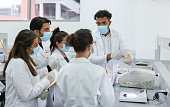 Students in a bacteriology class learning how to use a microscope