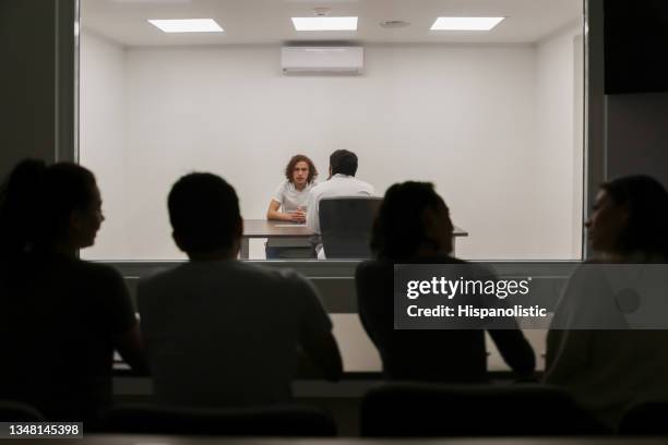 psicology students listening to a man in therapy - interrogation stock pictures, royalty-free photos & images