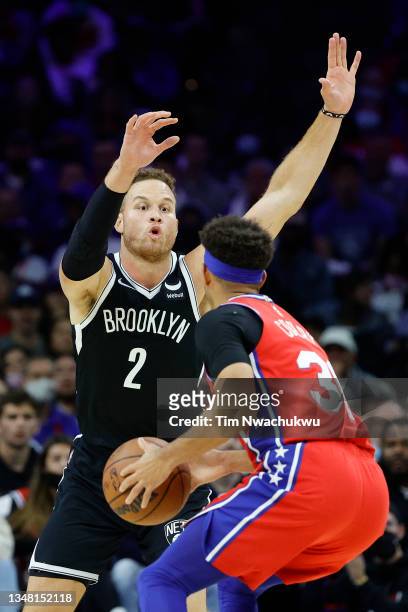 Blake Griffin of the Brooklyn Nets guards Seth Curry of the Philadelphia 76ers during the second quarter at Wells Fargo Center on October 22, 2021 in...