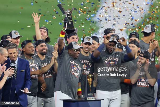 Manager Dusty Baker of the Houston Astros raises the William Harridge Trophy after defeating the Boston Red Sox 5-0 in Game Six of the American...