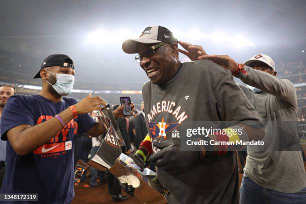 Manager Dusty Baker of the Houston Astros celebrates with the William Harridge Trophy after defeating the Boston Red Sox 5-0 in Game Six of the...