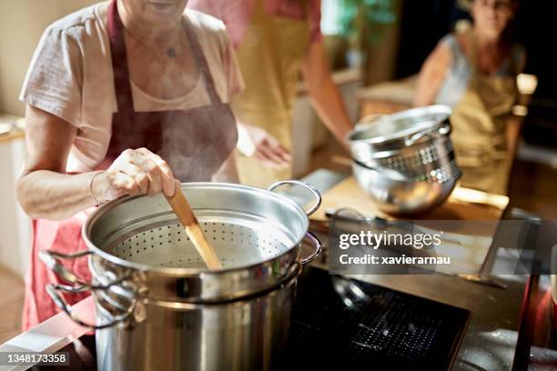 instructor and students cooking with steam pots - cookery class stock pictures, royalty-free photos & images