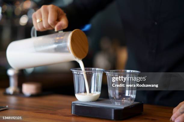 barista pouring milk to cup prepare to make coffee serve - cup sizes stock pictures, royalty-free photos & images