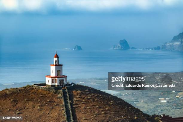 bell tower on a mountain with the sea in the background - hierro bildbanksfoton och bilder