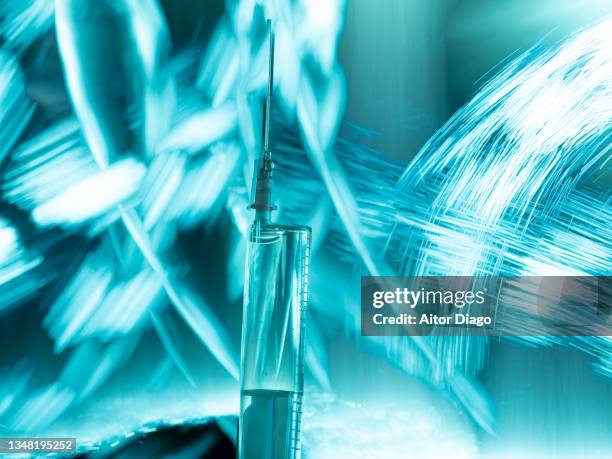 creative image of a syringe with liquid inside. covid-19 vaccine. - gegengift stock-fotos und bilder