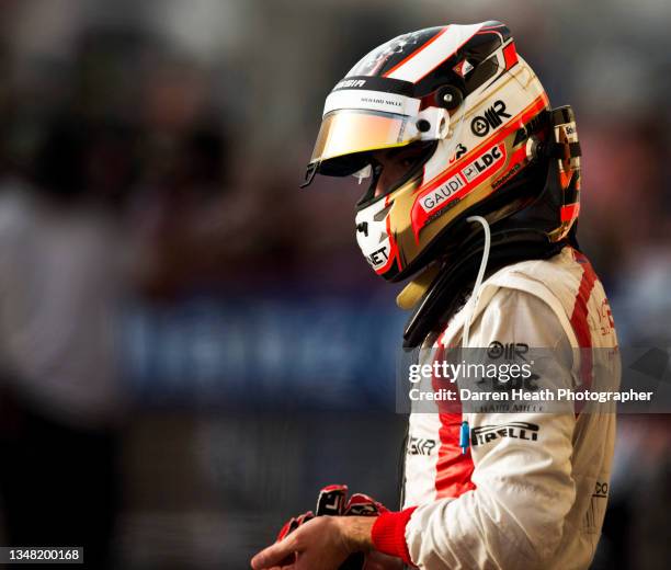 French Marussia Formula One team racing driver Jules Bianchi standing in the post race Parc Férme wearing his fire proof protection suit racing...