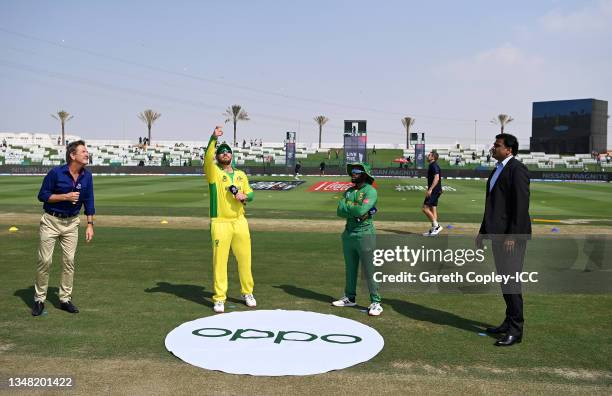 Aaron Finch of Australia flips the coin as Temba Bavuma of South Africa looks on ahead of the ICC Men's T20 World Cup match between Australia and SA...