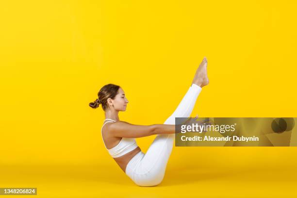 sportive woman doing yoga exercise for muscle pres workout. sport and healthy lifestyle concept - pilates 個照片及圖片檔