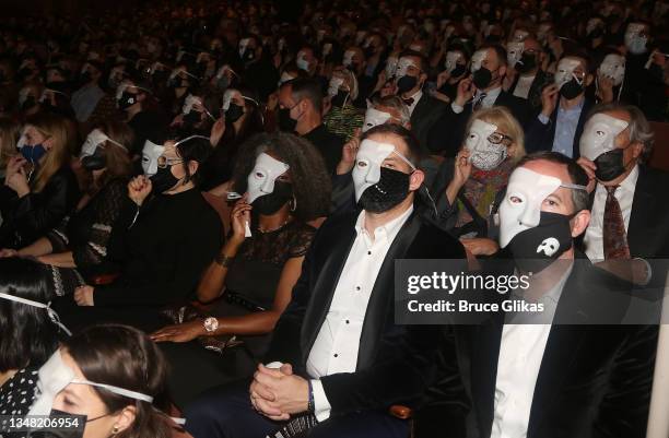 The audience is given phantom masks to wear during the re-opening night performance of"Phantom Of The Opera" on Broadway at The Majestic Theatre on...