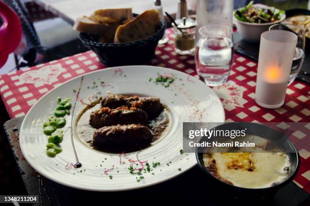 savoyard meat sausages served with cheese fondue in annecy, french alps - annecy stock-fotos und bilder