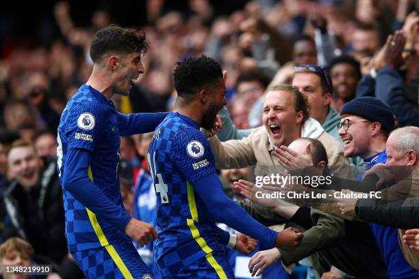 Reece James of Chelsea celebrates with teammate Kai Havertz and the fans after scoring their side's third goal during the Premier League match...