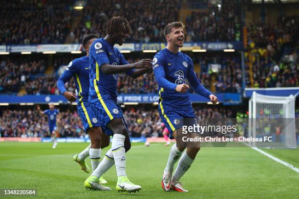 Mason Mount of Chelsea celebrates with teammate Trevoh Chalobah after scoring their side's first goal during the Premier League match between Chelsea...