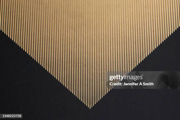 gold striped triangle - oro fotografías e imágenes de stock