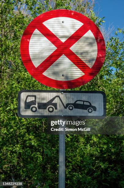 no stopping, tow away zone road warning signs in a city street - car towing imagens e fotografias de stock