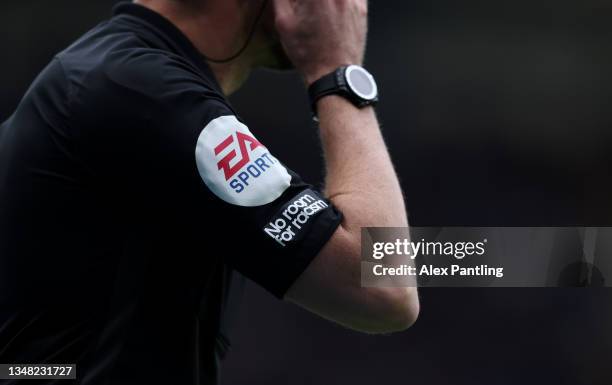 General view of the 'No room for racism' and EA Sports sleeve badges on the shirt of the assistant referee during the Premier League match between...