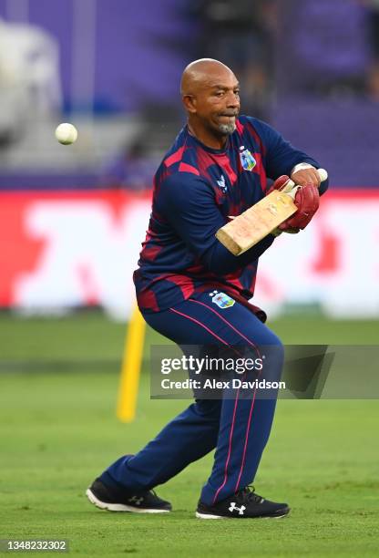 Phil Simmons, Head Coach of West Indies plays a shot ahead of the ICC Men's T20 World Cup match between England and Windies at Dubai International...