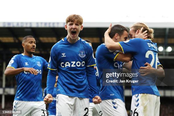 Tom Davies of Everton celebrates with teammates Seamus Coleman and Anthony Gordon after scoring their side's first goal during the Premier League...