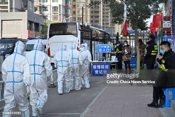 Medical workers wearing personal protective equipment arrive at a residential community where residents are under lockdown to halt the spread of the...