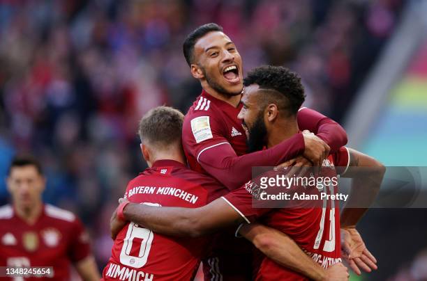 Eric Maxim Choupo-Moting celebrates with teammates Joshua Kimmich and Corentin Tolisso of FC Bayern Muenchen after scoring their team's third goal...