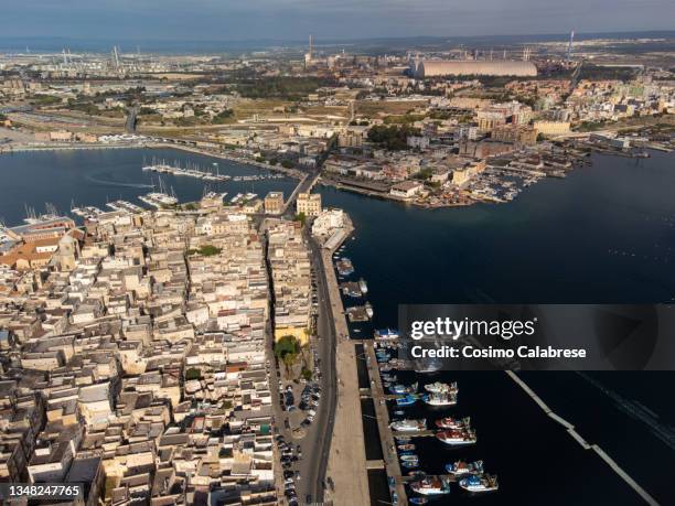 aerial view of the old town and the industrial area in taranto, apulia, italy - taranto stock-fotos und bilder