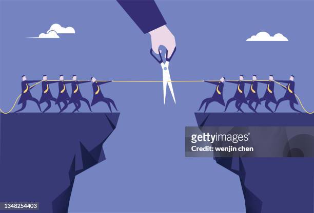 use scissors to cut the ropes of two teams tug-of-war on the cliff. - rope stock illustrations