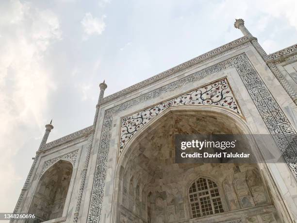 the famous taj mahal a white marble mausoleum - marble tomb stock pictures, royalty-free photos & images