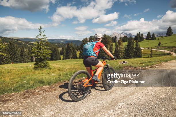 female mountain biker on active vacations in the dolomites - claus lange stock pictures, royalty-free photos & images