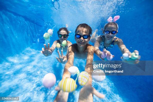 kids playing underwater during summer easter - kids pool games stock pictures, royalty-free photos & images