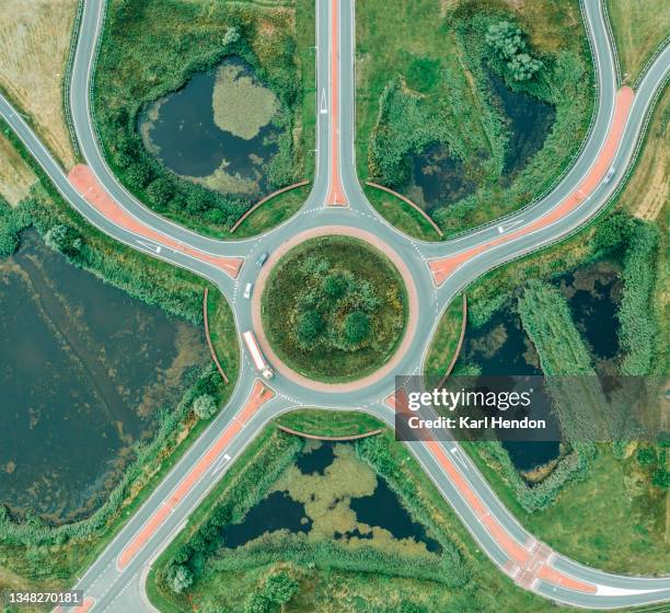 a daytime aerial view of a road junction - stock photo - kreisverkehr stock-fotos und bilder