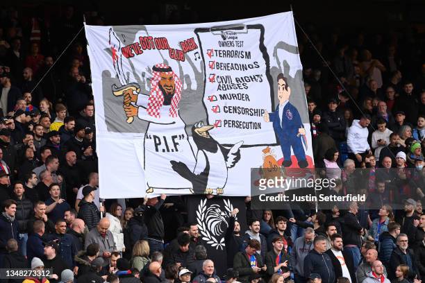 Banner relating to the owners of Newcastle United is seen in the home end during the Premier League match between Crystal Palace and Newcastle United...