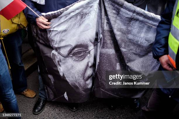 Supporters of the Fidesz party hold a placard of Ferenc Gyurcsány, former Prime Minister of Hungary during a peace march on October 23, 2021 in...