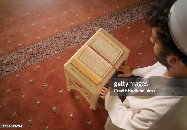 muslim cleric imam reading quran in mosque. - imam stock pictures, royalty-free photos & images