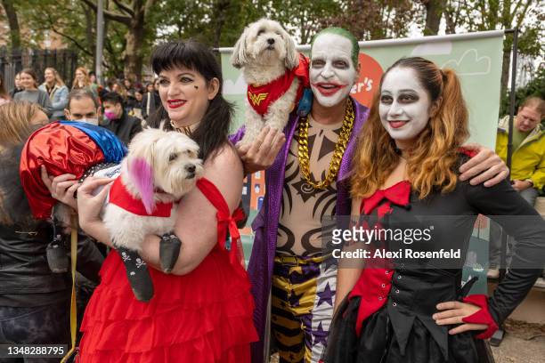 People and their dogs dressed in "Suicide Squad" costumes at the Annual Tompkins Square Halloween Dog Parade on October 23, 2021 in New York City....