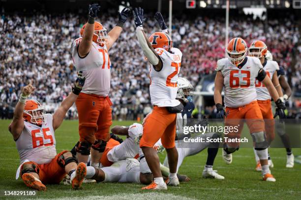 The Illinois Fighting Illini celebrate a two point conversion in the eighth overtime by Isaiah Williams during their game against the Penn State...