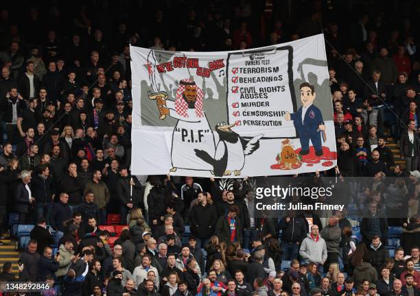 Crystal Palace fans display a banner attacking the Premier League for approving Newcastle’s Saudi-backed takeover seen before the Premier League...