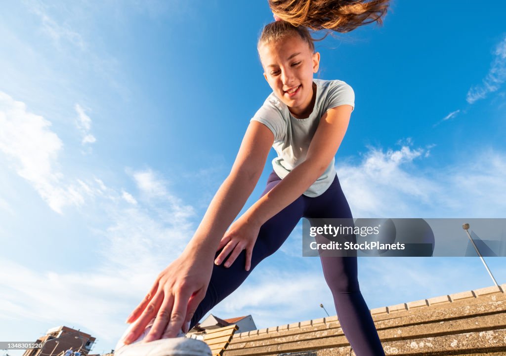 Cute girl stretching after exercising