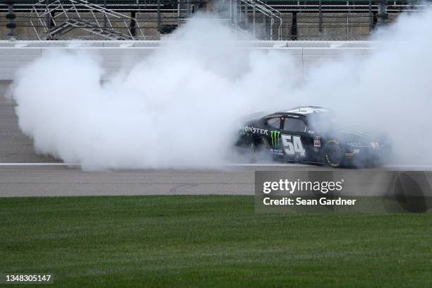 Ty Gibbs, driver of the Monster Energy Toyota, celebrates with a burnout after winning the NASCAR Xfinity Series Kansas Lottery 300 at Kansas...