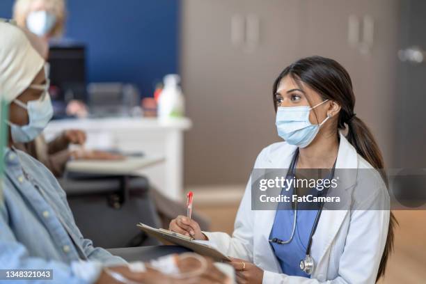 doctor talking with a cancer patient - cancer prevention stock pictures, royalty-free photos & images