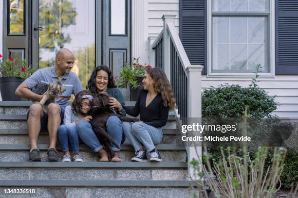 family in front of their house - family with pet stock pictures, royalty-free photos & images