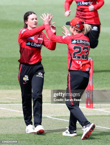 Courtney Webb of the Melbourne Renegades celebrates with her captain Sophie Molineux after getting the wicket of Nicole Bolton of the Sydney Sixers...