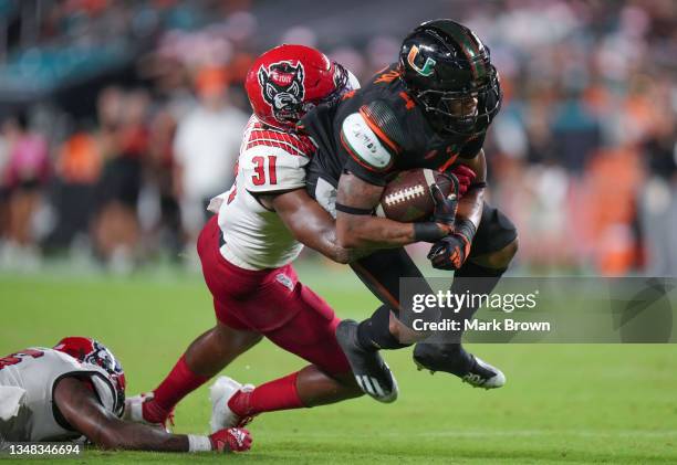 Jaylan Knighton of the Miami Hurricanes runs with the ball against the North Carolina State Wolfpack during the second half at Hard Rock Stadium on...