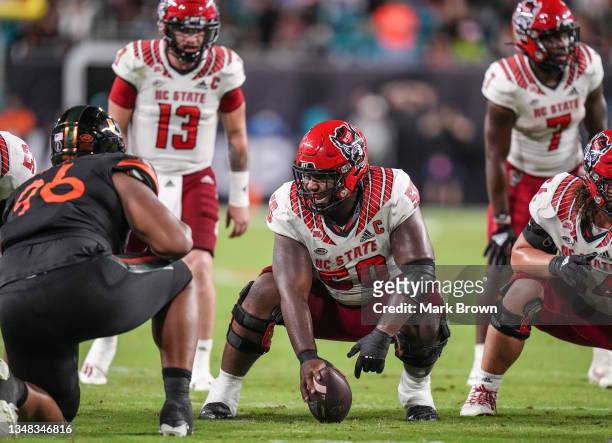 Grant Gibson of the North Carolina State Wolfpack shouts lineman signals prior to the snap against the Miami Hurricanes during the second half at...