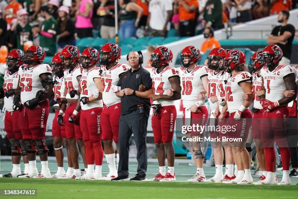 Head Coach Dave Doeren of the North Carolina State Wolfpack stands with the team during the National Anthem prior to the game against the Miami...