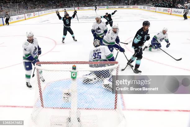 The Seattle Kraken celebrate a goal by Vince Dunn past Thatcher Demko of the Vancouver Canucks in the first period during the Kraken's inaugural home...