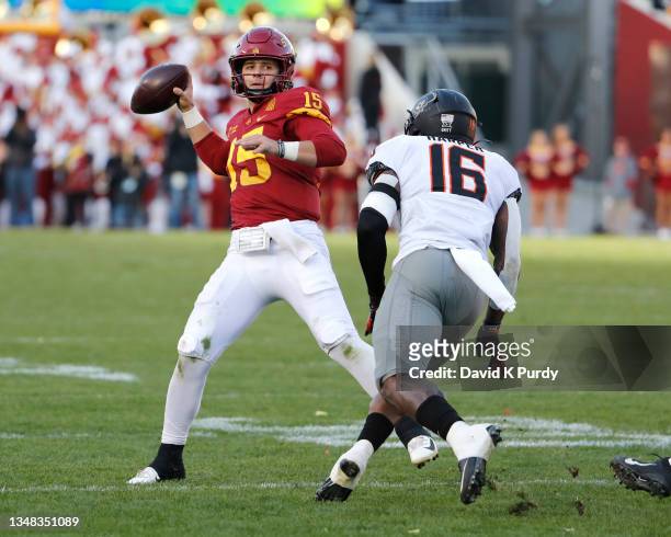 Quarterback Brock Purdy of the Iowa State Cyclones throws the ball as linebacker Devin Harper of the Oklahoma State Cowboys scrambles for yards in...