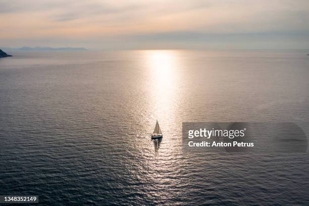 yacht in the open sea at sunset. yachting, luxury vacation at sea - greece landscape stock pictures, royalty-free photos & images