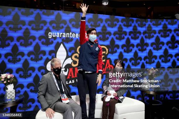 Vincent Zhou of the United States celebrates in the Kiss & Cry with his coaches Tom Zakrajsek and Mie Kamada after the Men's Free Skate during the...