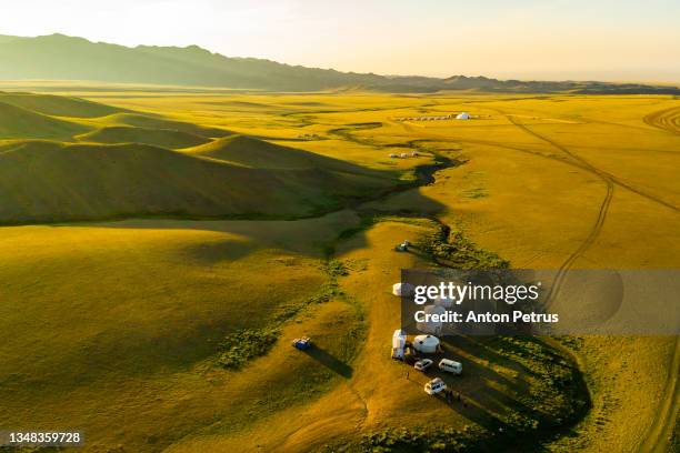 yurts at sunset in the foothills of altai. mongolia - rundzelt stock-fotos und bilder